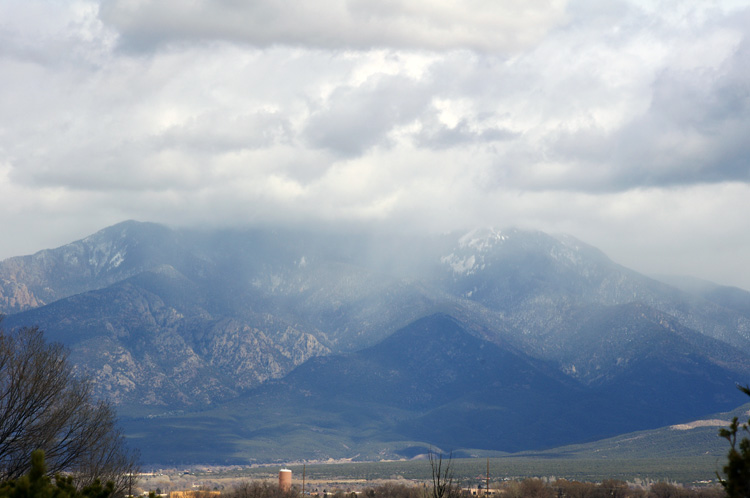 Snow moving in over Taos Mountain