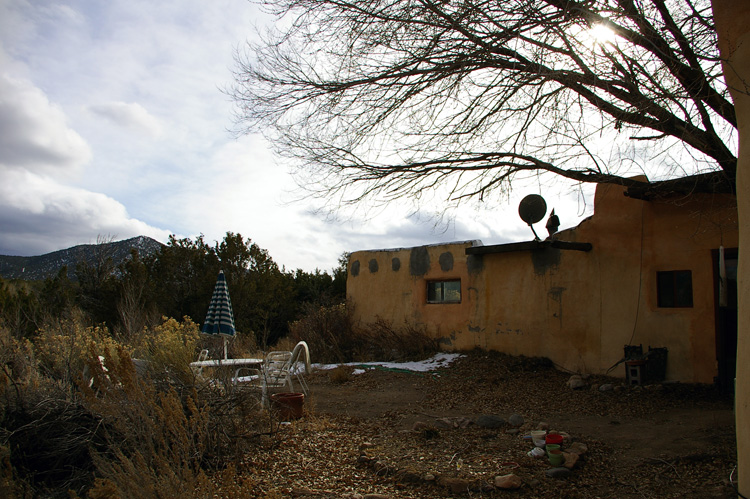 This winter backyard is typical for an old adobe in Taos.