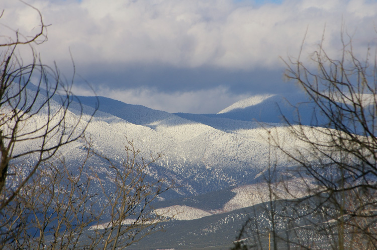Clouds over snowy mountains near Taos, NM.