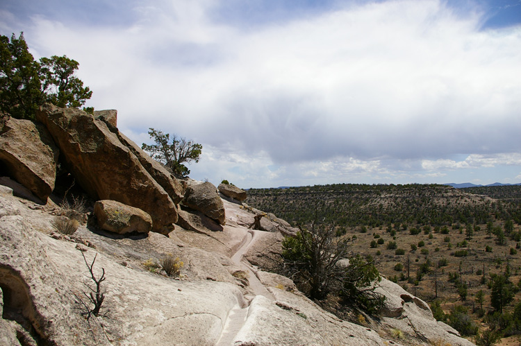 A view of Tsankawi with a trail worn into the soft volcanic tuff