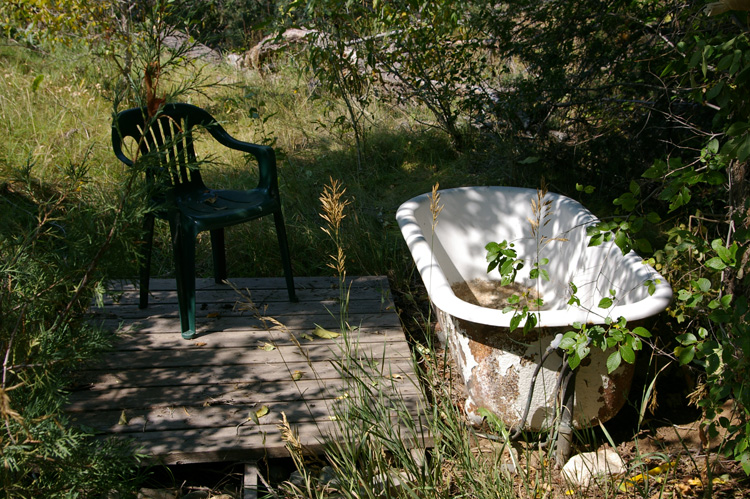 A working bathtub in the woods in a northern New Mexico village.