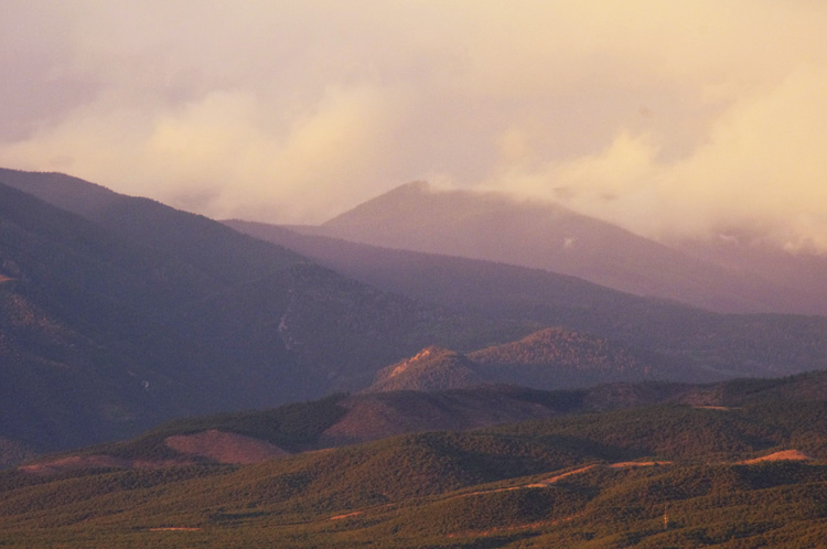 Old Mike Peak with clouds and Taos Pueblo lands at sunset